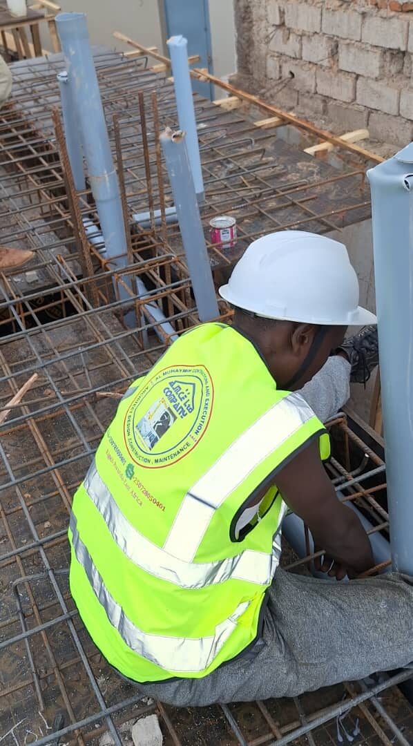 Team preparing reinforcement steel on foundation slab
