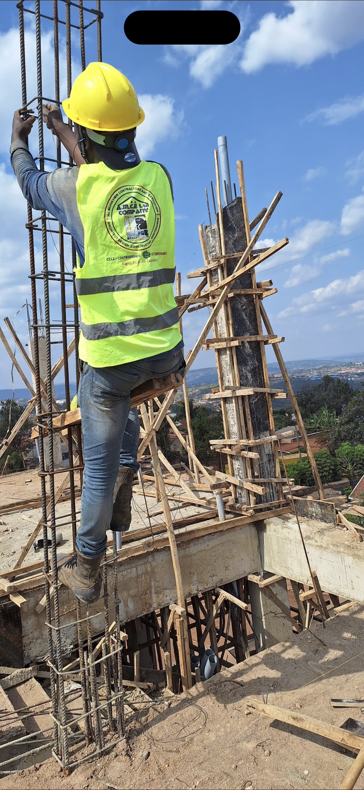 AMCE site engineer securing rebar column above Kigali