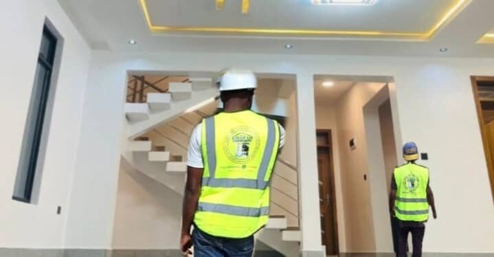Site team walking through finished interior with staircase