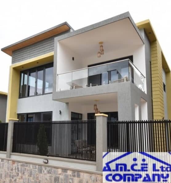 Completed modern villa with glass balcony and yellow accents