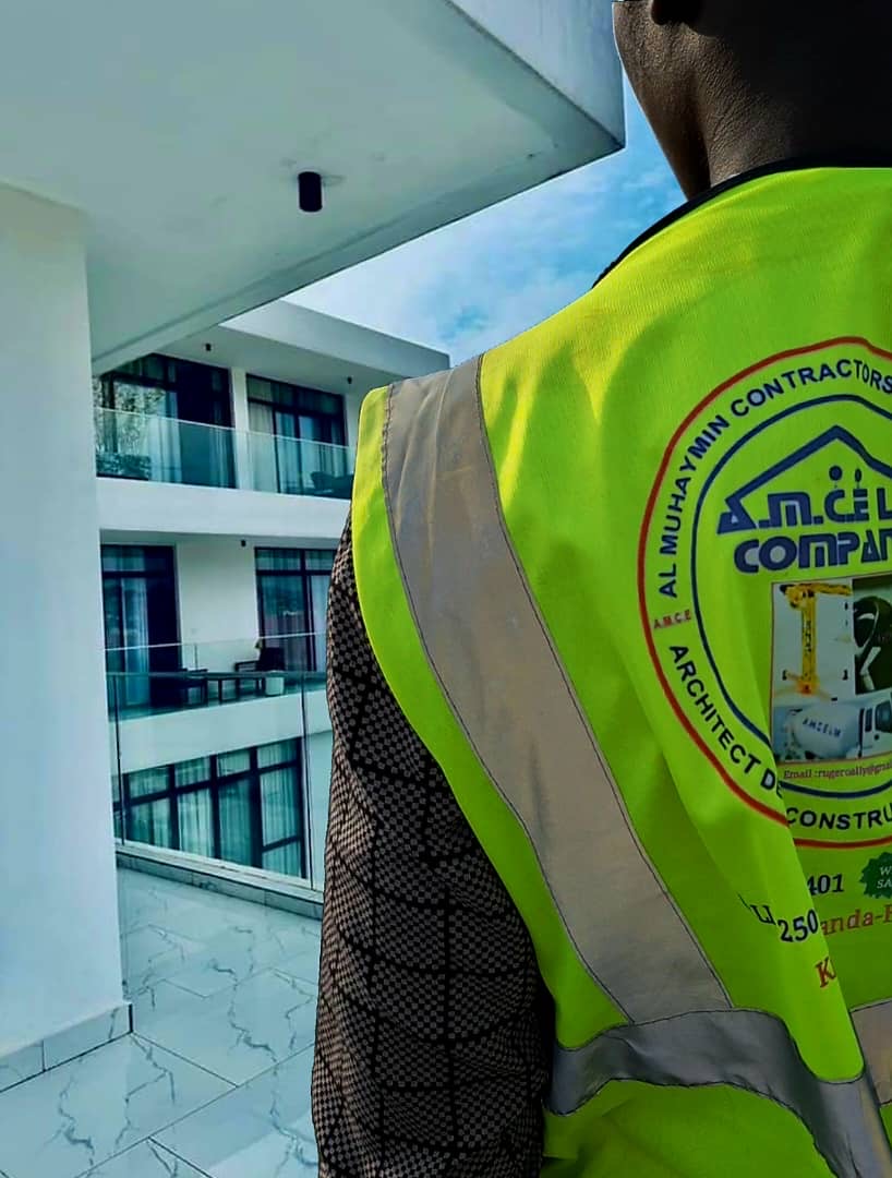 AMCE worker on the balcony of a nearly finished modern building