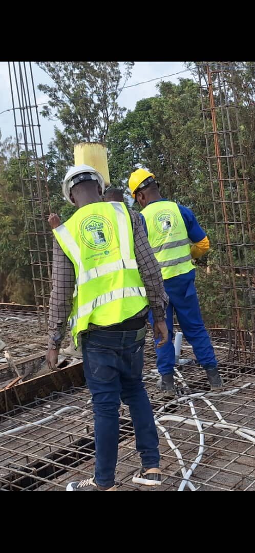 Workers reviewing rebar layout on rooftop slab